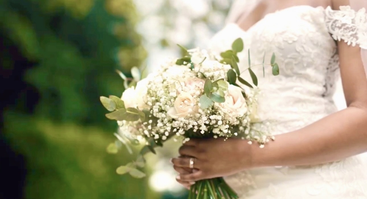 Bride holding a bouquet of blush roses, gypsophila and eucalyptus